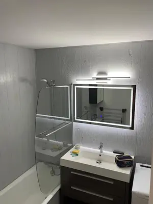 a bathroom with a sink and a mirror and a tub at Grand studio Combloux - Vue Mont Blanc in Combloux