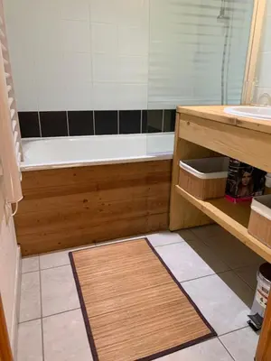 a bathroom with a bath tub and a sink at Les fermes de saint gervais in Saint-Gervais-les-Bains