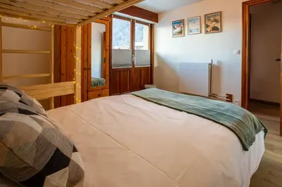 a bedroom with a large bed in a room at Les Trois Balcons Apartment - Chamonix All Year in Chamonix-Mont-Blanc