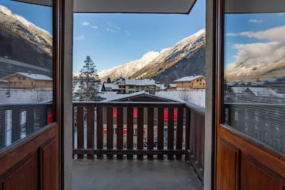 a view of a snowy mountain from a balcony at Les Trois Balcons Apartment - Chamonix All Year in Chamonix-Mont-Blanc
