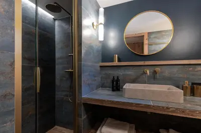 a bathroom with a sink and a mirror at Ferme des Choseaux - Grand Confort et ski in Combloux