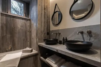 a bathroom with two sinks and mirrors on the wall at Ferme des Choseaux - Grand Confort et ski in Combloux