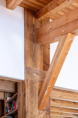 a wooden wall in a room with wooden beams at MEGEVE Chalet d'architecte pour 16 personnes in Megève