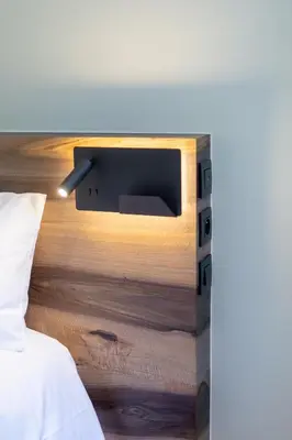 a bedroom with a bed with a tv on a table at MEGEVE Chalet d'architecte pour 16 personnes in Megève