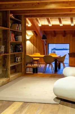a living room with a table and chairs at MEGEVE Chalet d'architecte pour 16 personnes in Megève