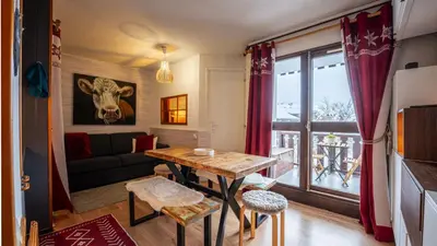 a living room with a table and a couch at Grande Neige N 33 - 2P5 in Morillon