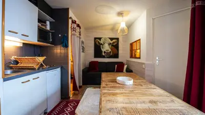 a kitchen with a table with a cow head on the wall at Grande Neige N 33 - 2P5 in Morillon