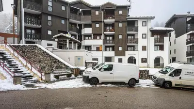 two cars parked in a parking lot in front of a building at Grande Neige N 33 - 2P5 in Morillon