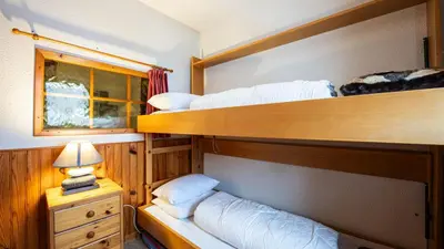 a bedroom with two bunk beds and a lamp at Grande Neige N 33 - 2P5 in Morillon