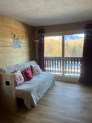 a bedroom with a bed and a large window at Carroz d Araches , 2 pièces rénové vue montagne, 4 personnes, 3 min du centre, parking,balcon in Arâches-la-Frasse