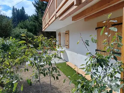 a courtyard of a house with trees and a building at Karibu in Saint-Gervais-les-Bains