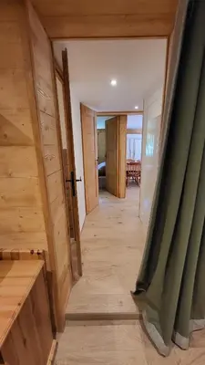 a hallway of a house with a green curtain at Karibu in Saint-Gervais-les-Bains