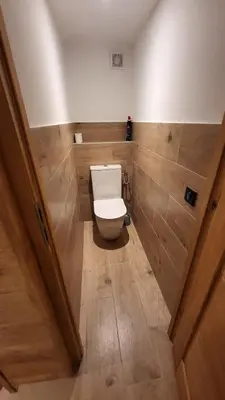 a bathroom with a white toilet in a room at Karibu in Saint-Gervais-les-Bains