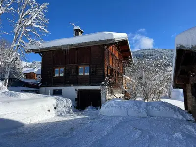 a log cabin in the snow with snow covered trees at Chalet Mont-Joly 2 Megeve in Megève