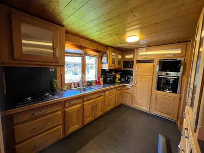 a bedroom in a log cabin with a bed and a window at Chalet Mont-Joly 2 Megeve in Megève