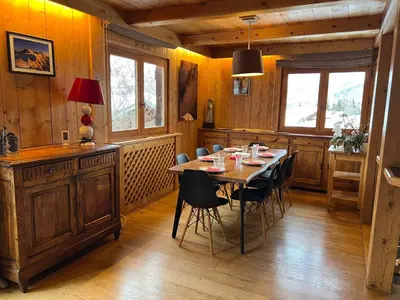 a dining room with a wooden table and chairs at Chalet Mont-Joly 2 Megeve in Megève