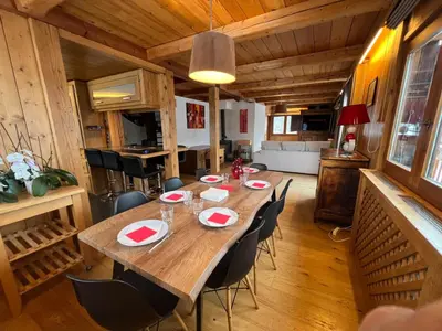 a dining room with a long table and chairs at Chalet Mont-Joly 2 Megeve in Megève