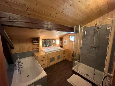 a kitchen with a large wooden island in a tiny house at Chalet Mont-Joly 2 Megeve in Megève