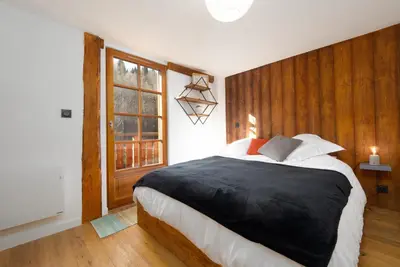 a bedroom with a large bed and a window at The Loft in Saint-Gervais-les-Bains