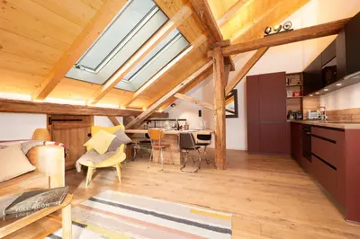 a kitchen and living room with wooden ceilings and skylights at The Loft in Saint-Gervais-les-Bains