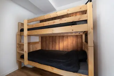 a wooden bunk bed in the corner of a room at The Loft in Saint-Gervais-les-Bains