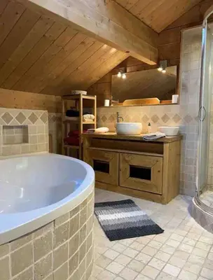 a large bathroom with a tub and a sink at Chamlomy in Chamonix-Mont-Blanc