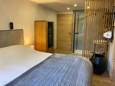a bedroom with a bed and a sliding glass door at Chamlomy in Chamonix-Mont-Blanc