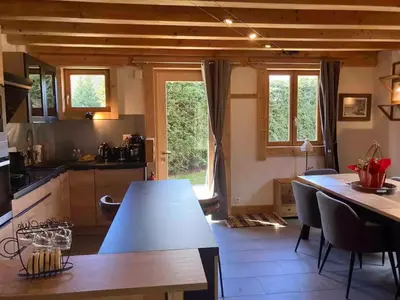 a kitchen and dining room with a table and chairs at Chamlomy in Chamonix-Mont-Blanc