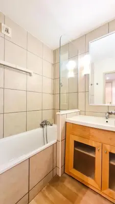 a bathroom with a tub and a sink and a mirror at Residence De La Foret - Appartement confortable · Au pied des pistes MAE-9991 in Magland