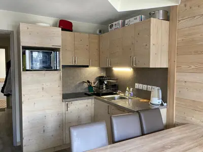 a wooden desk with a chair and a picture on the wall at Appartement skis aux pieds à Flaine avec parking et piscine - FR-1-425-227 in Arâches-la-Frasse