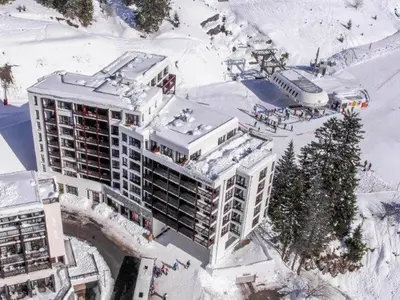 a kitchen with a wooden table and a dining room at Appartement skis aux pieds à Flaine avec parking et piscine - FR-1-425-227 in Arâches-la-Frasse