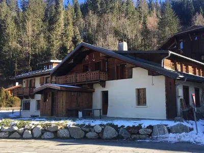 a house in the mountains with snow on the ground at Chalet familial et chaleureux in Les Contamines-Montjoie