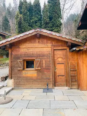 a small wooden building with a door and a window at Chalet familial et chaleureux in Les Contamines-Montjoie