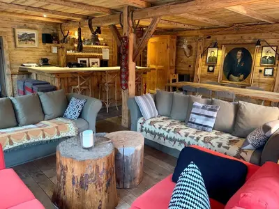 a living room with couches and tables in a cabin at Chalet familial et chaleureux in Les Contamines-Montjoie