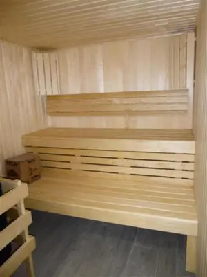 a sauna with a wooden bench in a room at Résidence Le Panoramic - Appartement lumineux · Départ et retour skis aux pieds · Piscine · Parking inclus · Spa · wifi MAE-0351 in Magland
