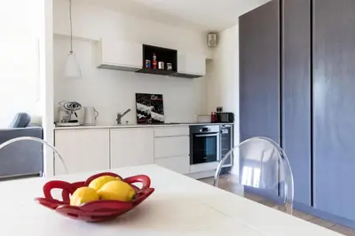 a kitchen with a bowl of fruit on a table at Le Majestic 145 Apartment - Chamonix All Year in Chamonix-Mont-Blanc