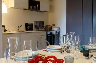 a table with wine glasses on it in a kitchen at Le Majestic 145 Apartment - Chamonix All Year in Chamonix-Mont-Blanc