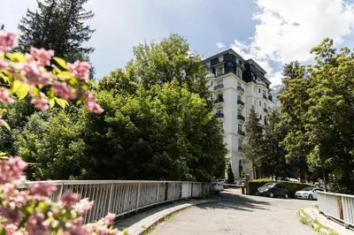 a white building with a fence in front of it at Le Majestic 145 Apartment - Chamonix All Year in Chamonix-Mont-Blanc