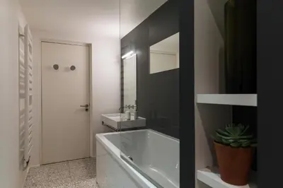 a white bathroom with a tub and a sink at Le Majestic 145 Apartment - Chamonix All Year in Chamonix-Mont-Blanc