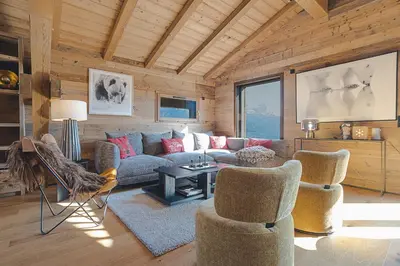 a living room with a couch and two chairs at Chalet Combloran in Combloux