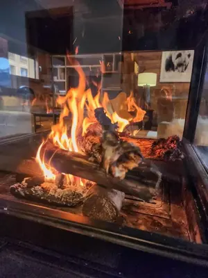 a grill with a bunch of food on fire at Chalet Combloran in Combloux