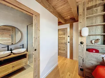 a bathroom with two sinks and a mirror at Chalet Combloran in Combloux