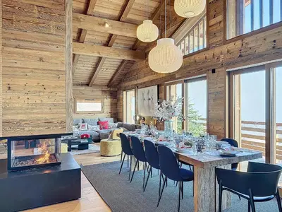 a dining room with a table and chairs at Chalet Combloran in Combloux