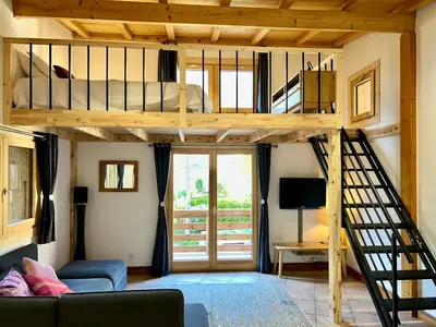 a loft bed in a room with a bunk bed at Private Loft Apartment, Central Chamonix in Chamonix-Mont-Blanc