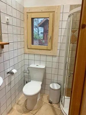 a bathroom with a toilet and a window at Private Loft Apartment, Central Chamonix in Chamonix-Mont-Blanc