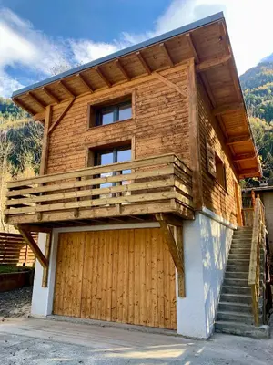 a house with a deck on the side of it at Private Loft Apartment, Central Chamonix in Chamonix-Mont-Blanc