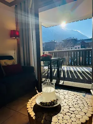 a view of a balcony with a candle on a table at Appartement Vu Mont Blanc parking Terrasse in Chamonix-Mont-Blanc