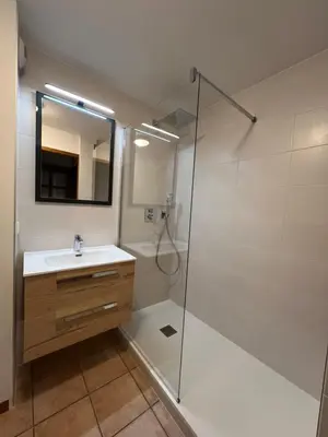 a bathroom with a shower and a sink and a mirror at Appartement Vu Mont Blanc parking Terrasse in Chamonix-Mont-Blanc