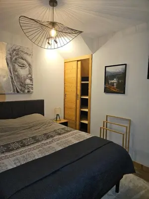 a bedroom with a bed and a chandelier at Apartment in Saint-Gervais close to gondola in Saint-Gervais-les-Bains