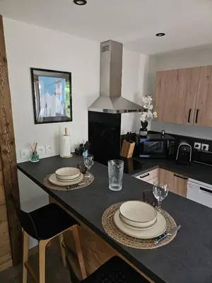 a kitchen with a table with plates and glasses on it at Apartment in Saint-Gervais close to gondola in Saint-Gervais-les-Bains